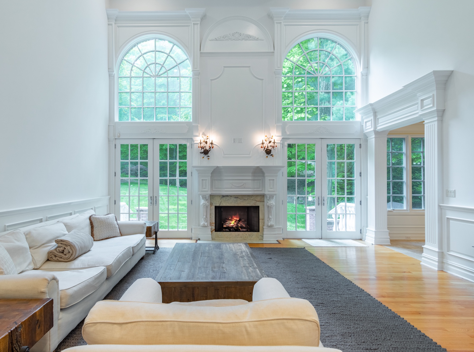 A completed residence seen across its lawn under low light