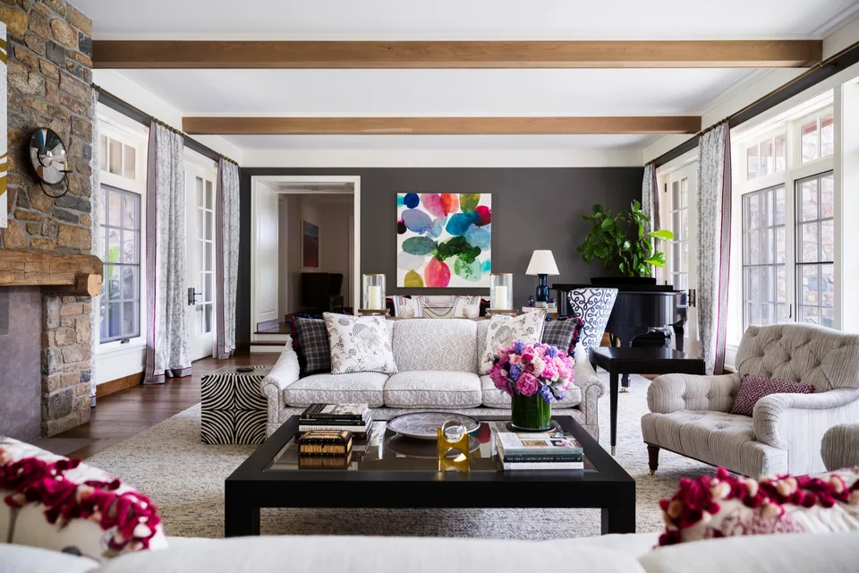 A furnished living room with a piano and colorful artwork
