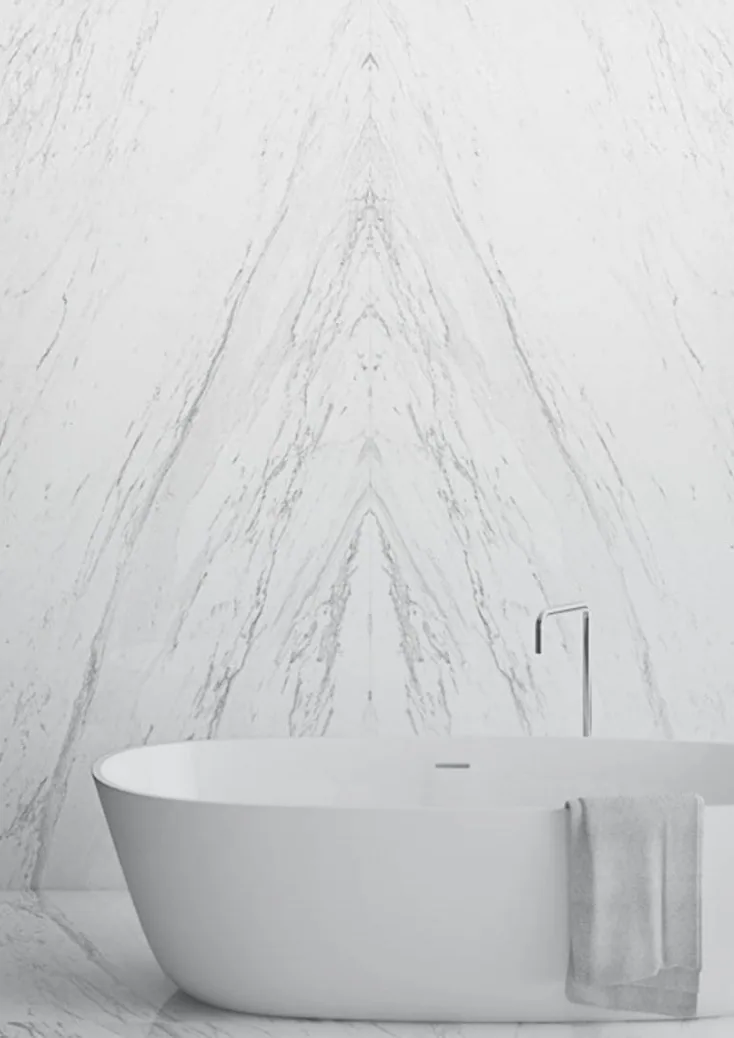 Bookmatched stone around a freestanding bath