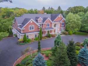 luxury home in bergen county with huge driveway in front of it